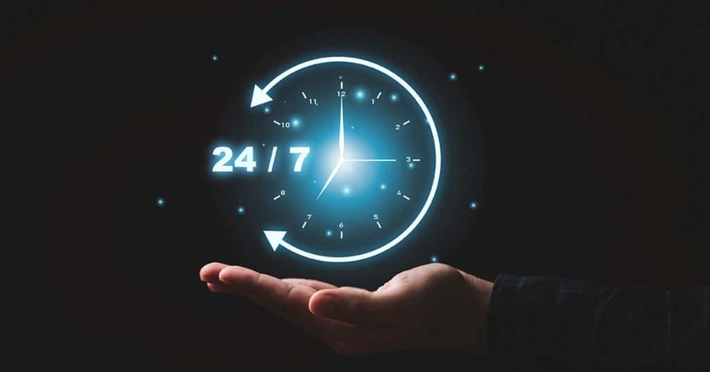 Hand holding glowing 24/7 support icon