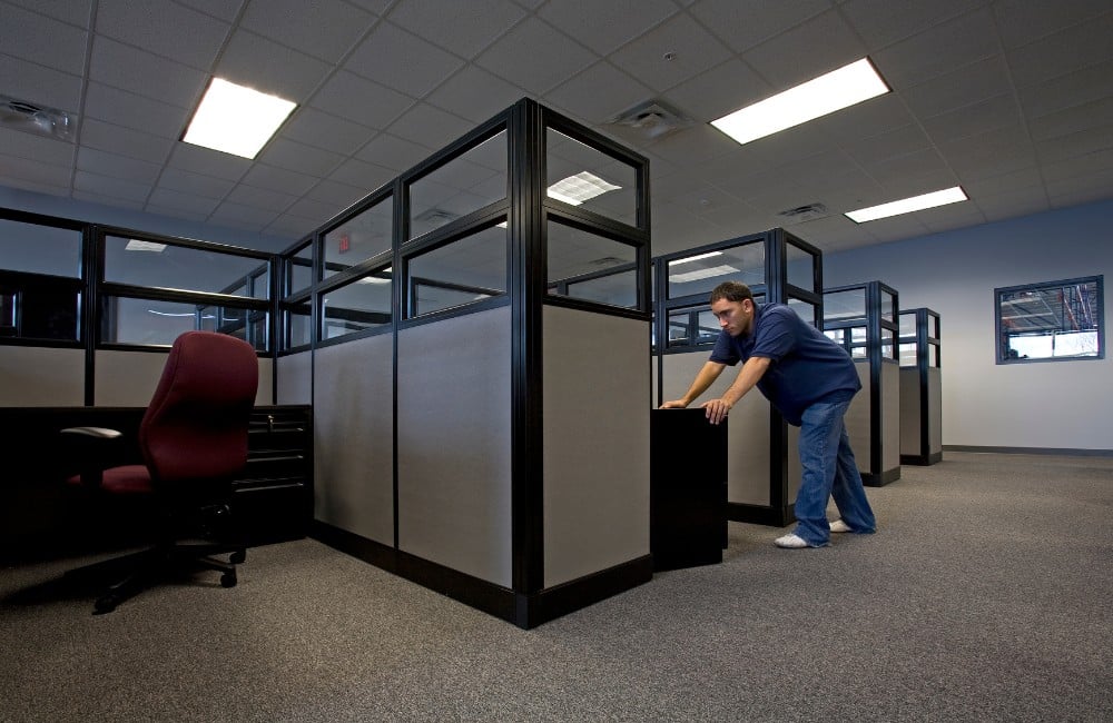 Technician working inside office cubicle area