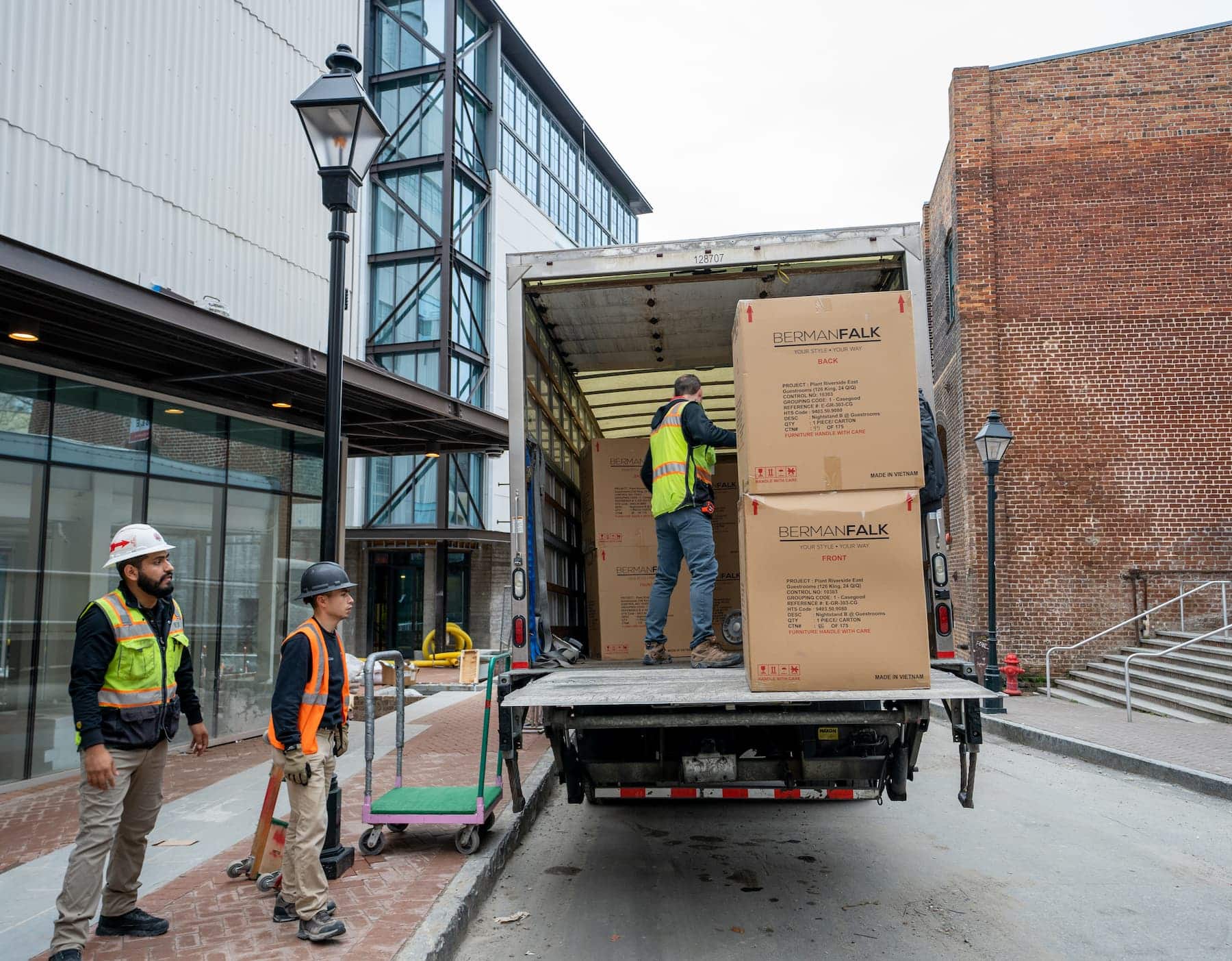 Delivery workers unloading boxes from a moving truck