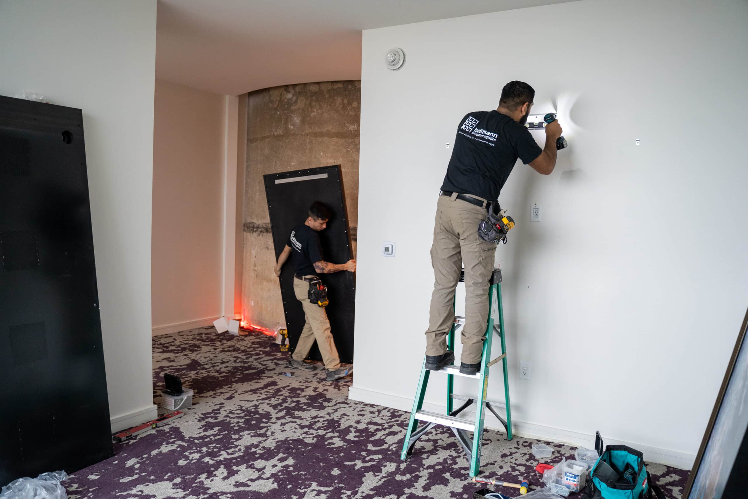 Worker painting or repairing interior wall