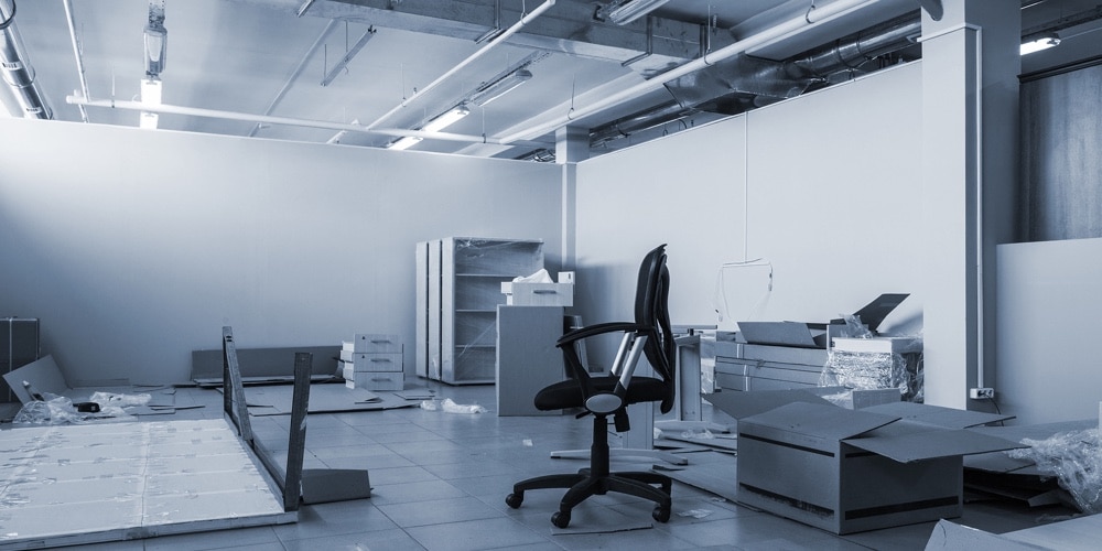 Empty modern office room with chair and exposed ceiling