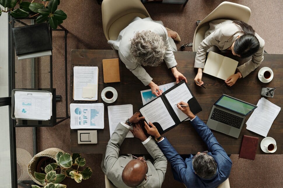 Business team reviewing paperwork at table