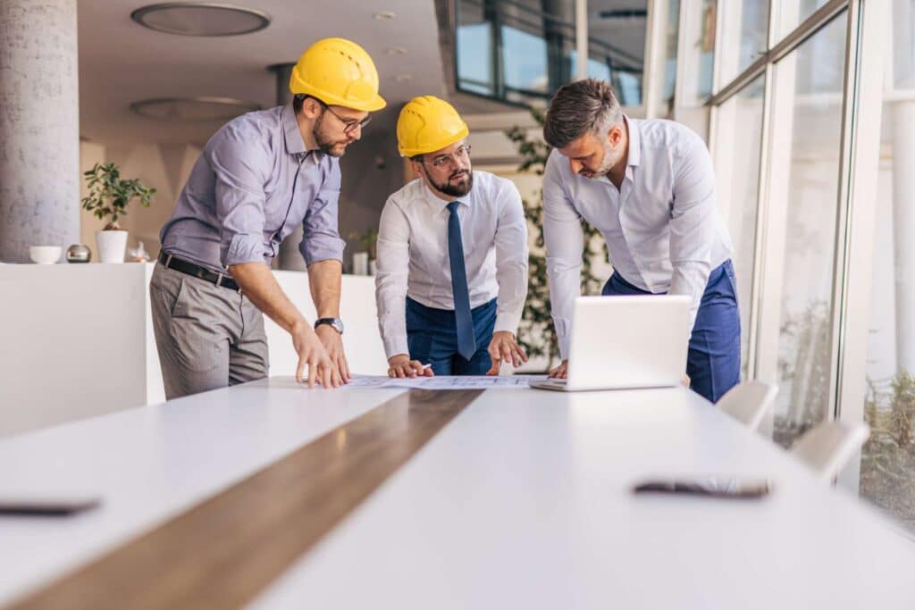 Construction team reviewing blueprints together