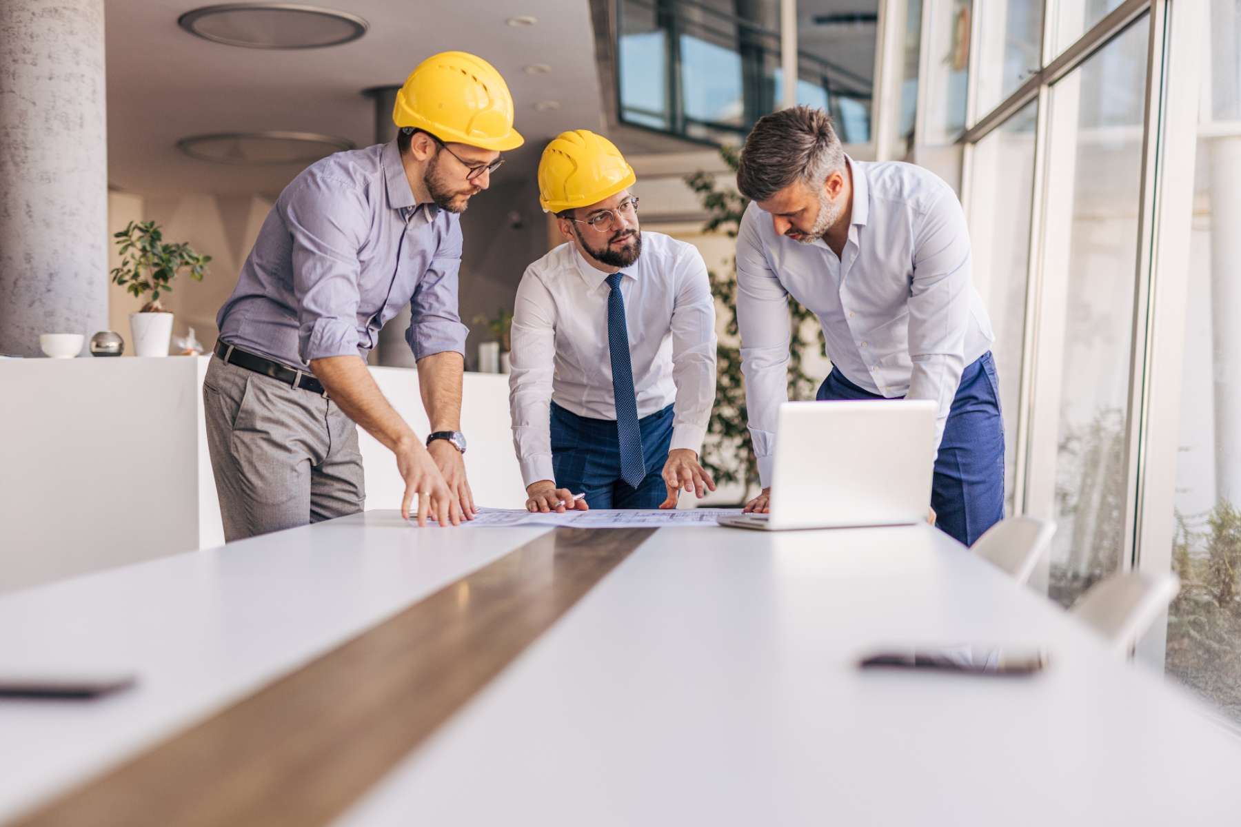 Construction team reviewing blueprints together