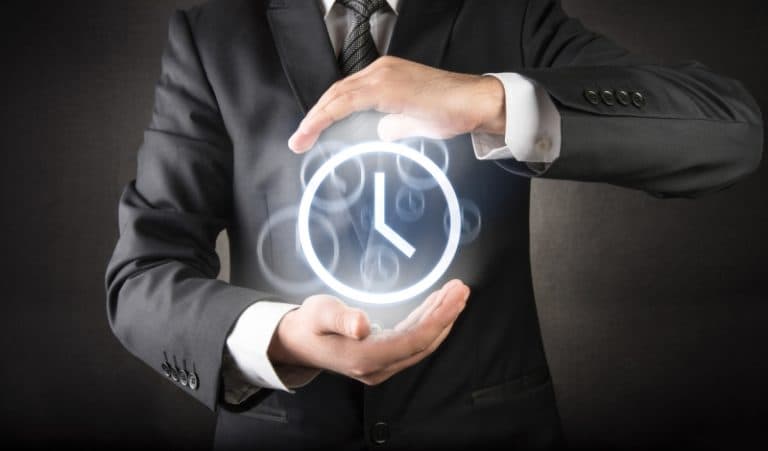 Business professional holding glowing clock icon
