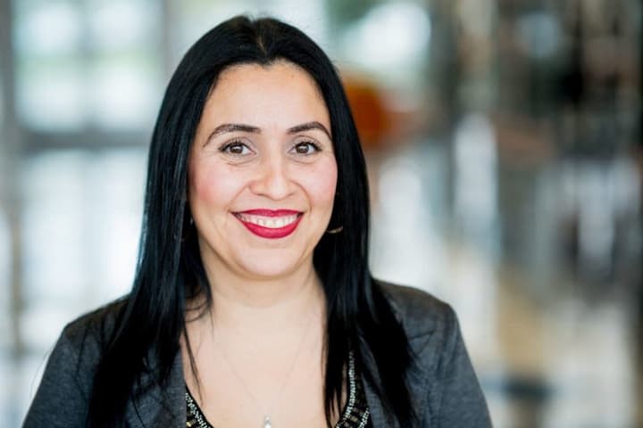 Professional headshot of Sandra Cadena in business attire indoors